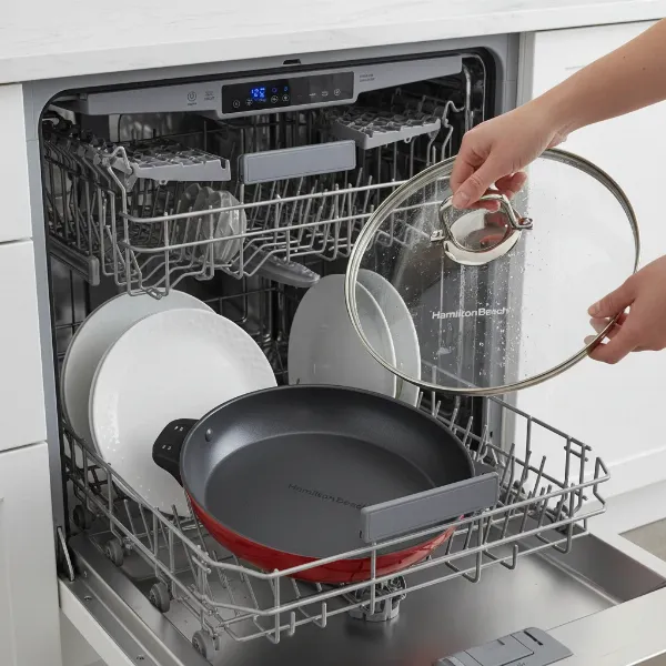 Hamilton Beach Durathon electric skillet pan and lid being placed into a dishwasher for easy cleaning.