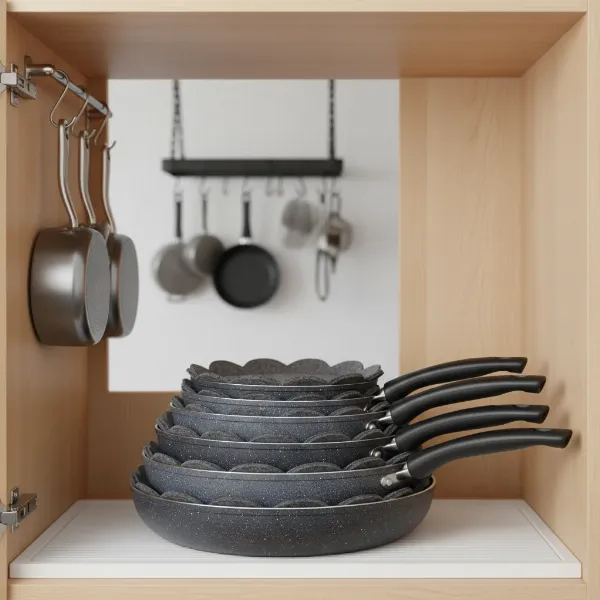 Stacked non-stick pans with felt protectors, preventing scratches and damage.