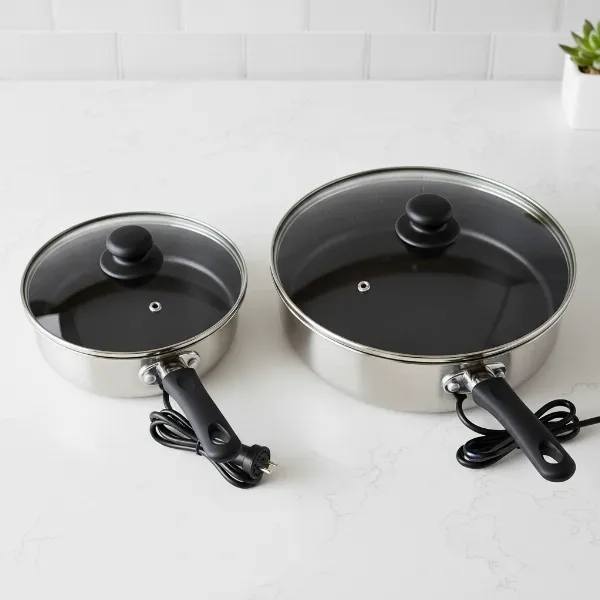 Two Toastmaster electric skillets, 6-inch and 12-inch, showcasing their size difference and features